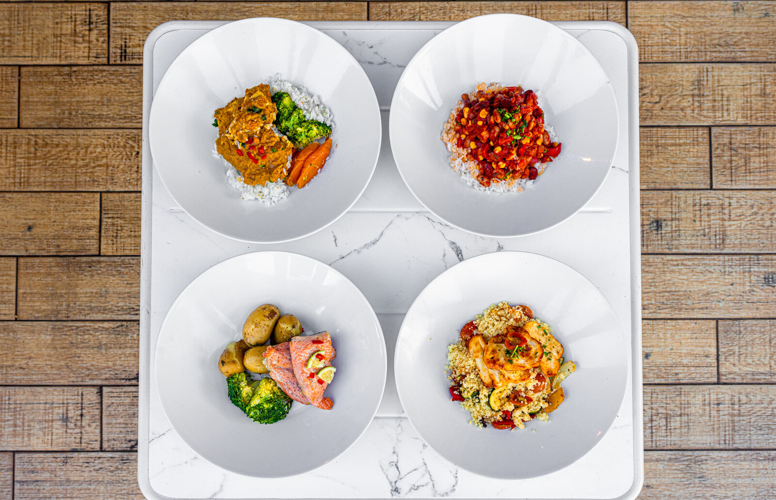 Four Prep 'N' Fresh dishes plated on a tray, cooked from scratch